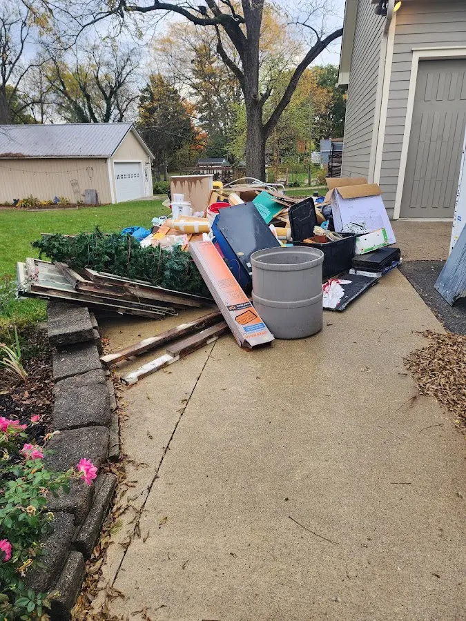Dumpster being loaded with debris for 30 Yard Dumpster Rental in Hinesburg